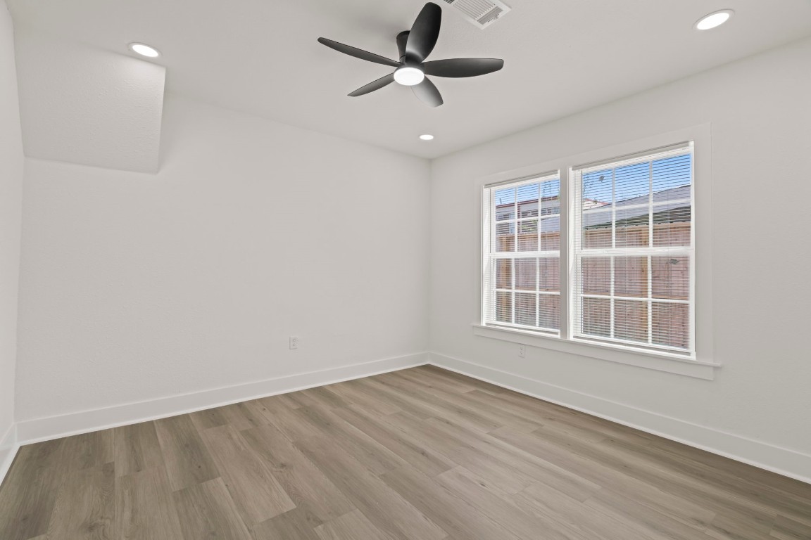2817 Winbern Street Houston, TX 77004 - Photo 16 of 23 a view of an empty room with a window and wooden floor