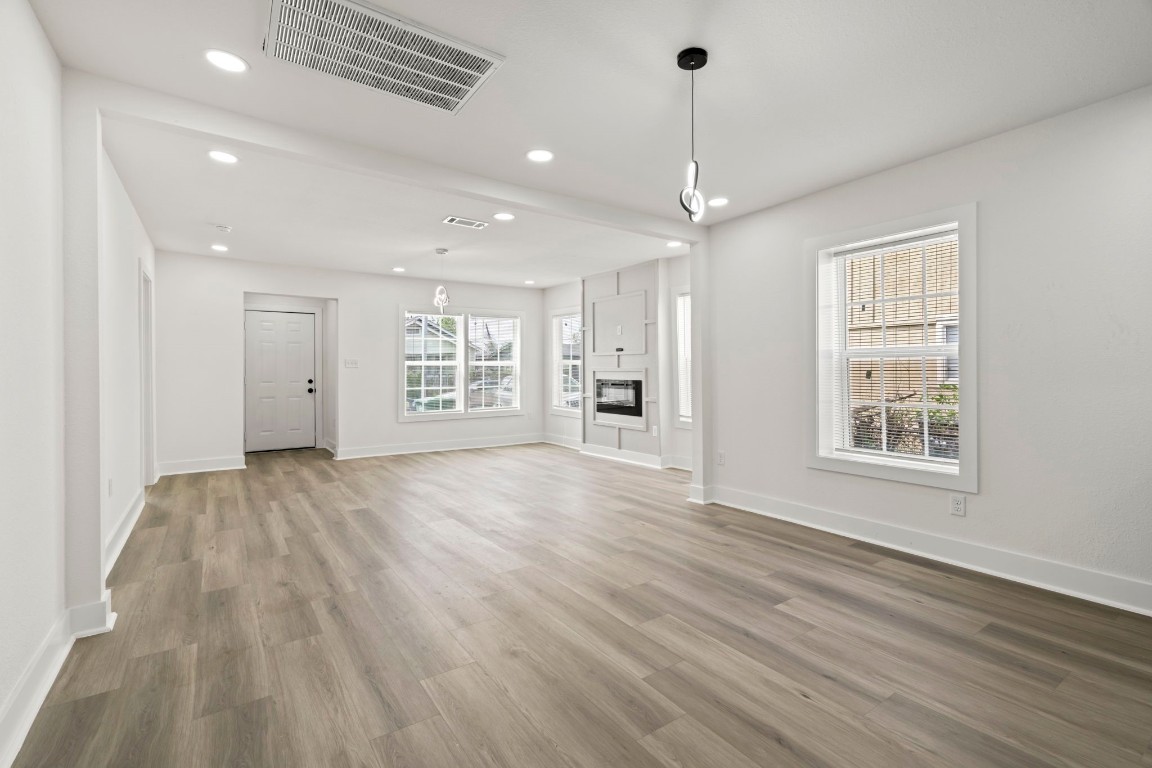 2817 Winbern Street Houston, TX 77004 - Photo 20 of 23 a view of an empty room with a window and wooden floor