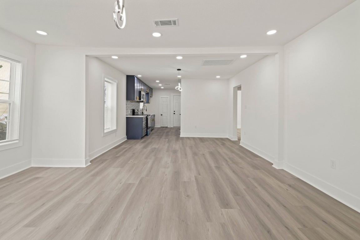 2817 Winbern Street Houston, TX 77004 - Photo 4 of 23 a view of empty room with wooden floor