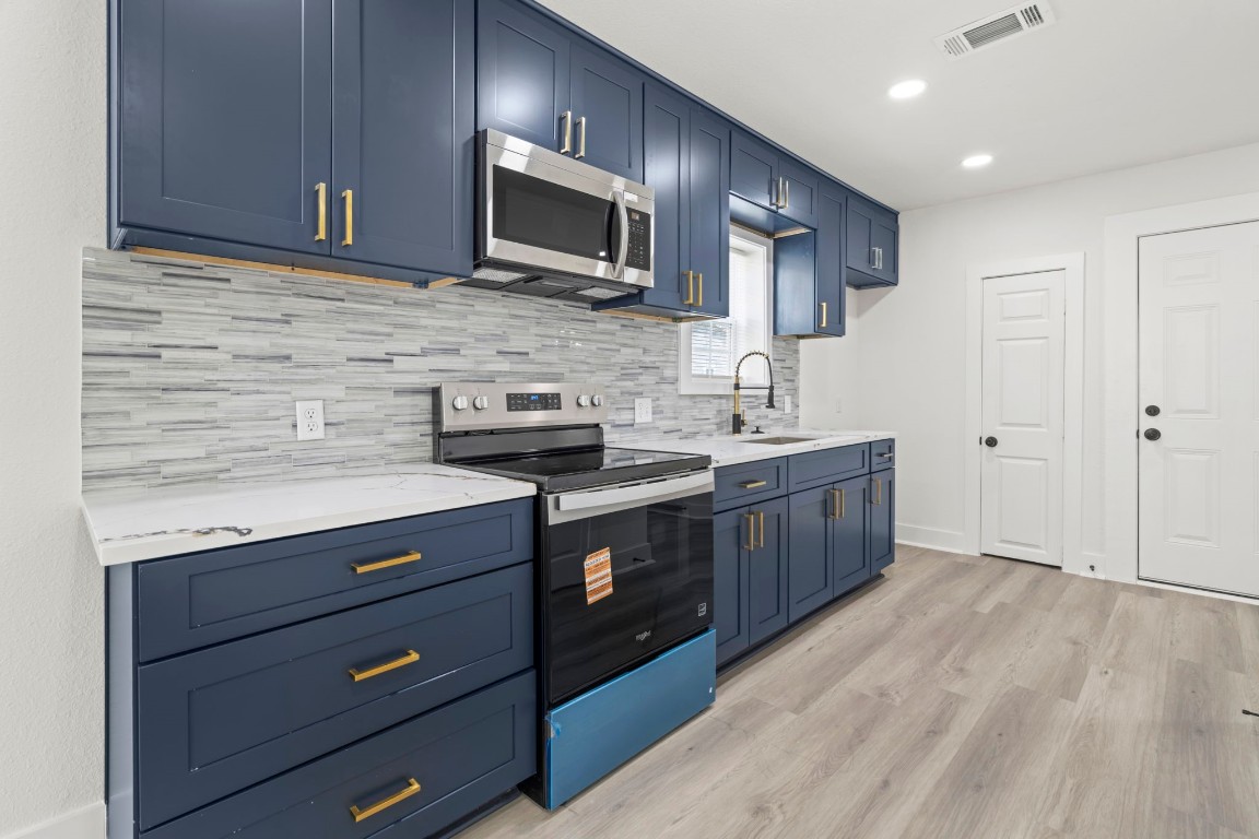 2817 Winbern Street Houston, TX 77004 - Photo 8 of 23 a kitchen with a sink stove and microwave