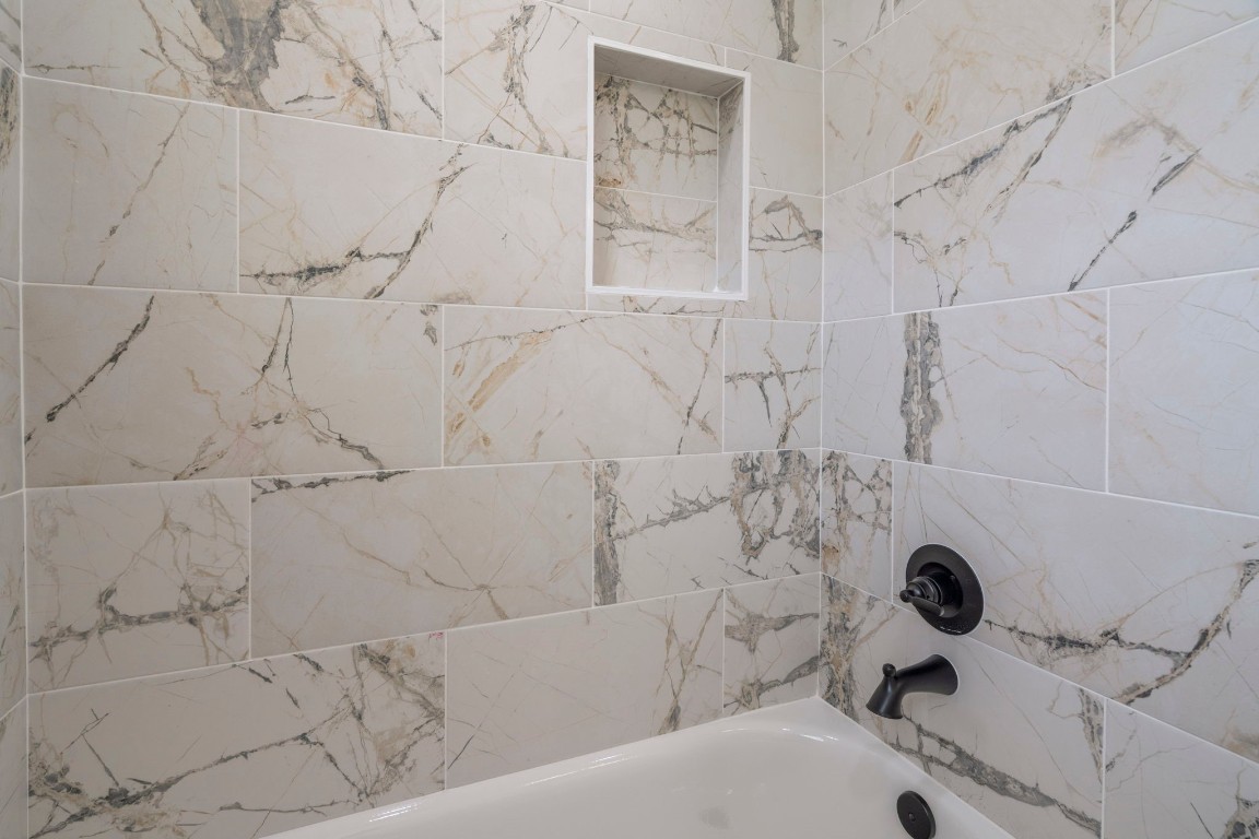 2817 Winbern Street Houston, TX 77004 - Photo 9 of 23 a bathroom with a bathtub and shower