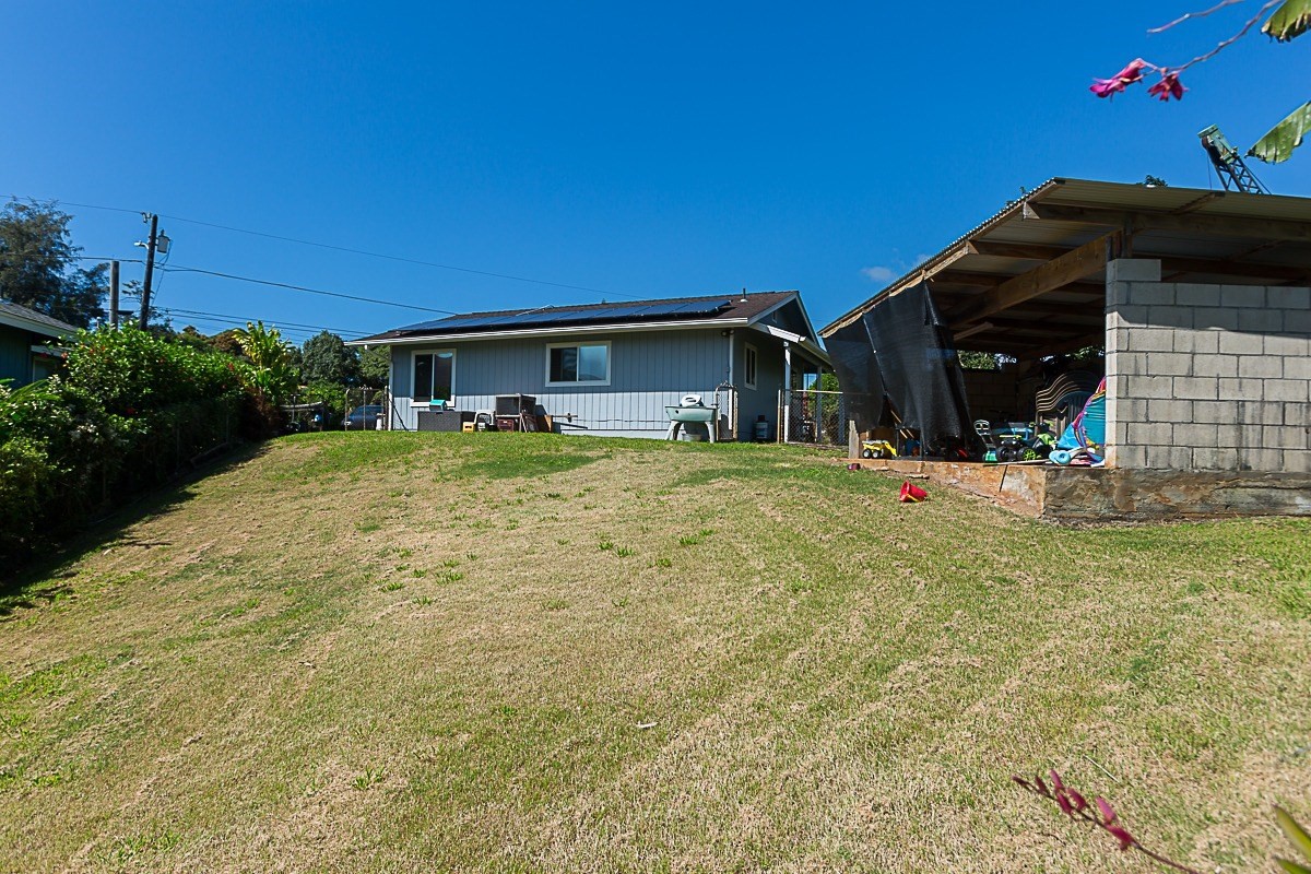 3280 Hailima Road Koloa, HI 96756 - Photo 8 of 13 a backyard of a house with lots of green space and fountain
