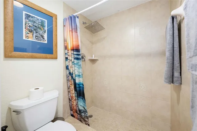 a bathroom with a toilet and a shower