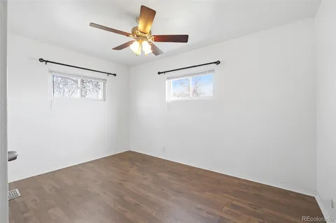 a yellow house with trees in front of it