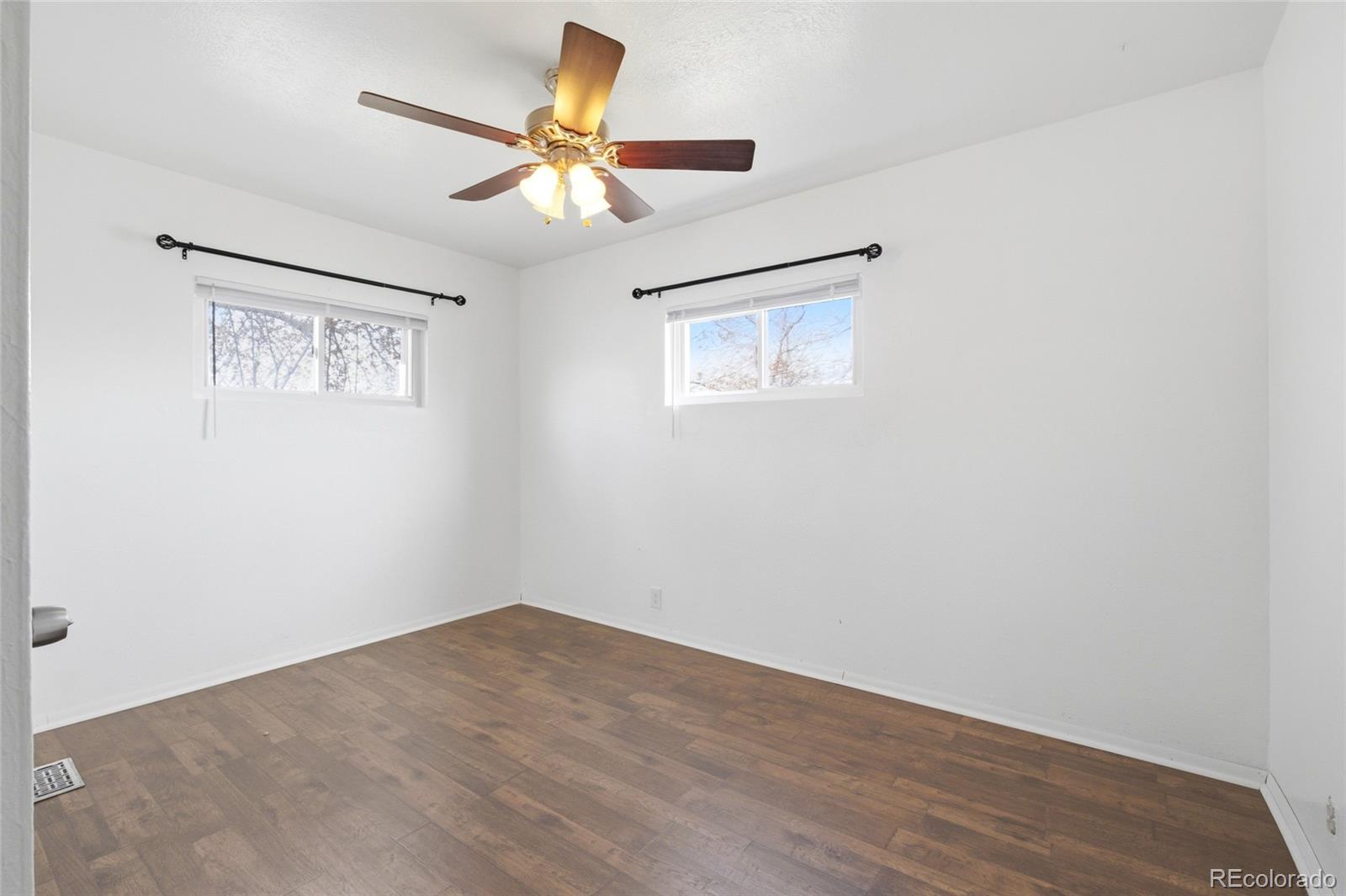 308 Fifth Street Dacono, CO 80514 - Photo 15 of 29 a view of a ceiling fan with wooden floor