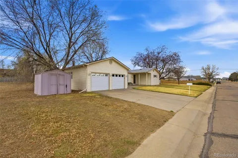 an empty room with wooden floor and a window