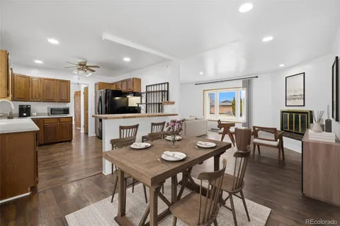 a large kitchen with a center island and wooden floor