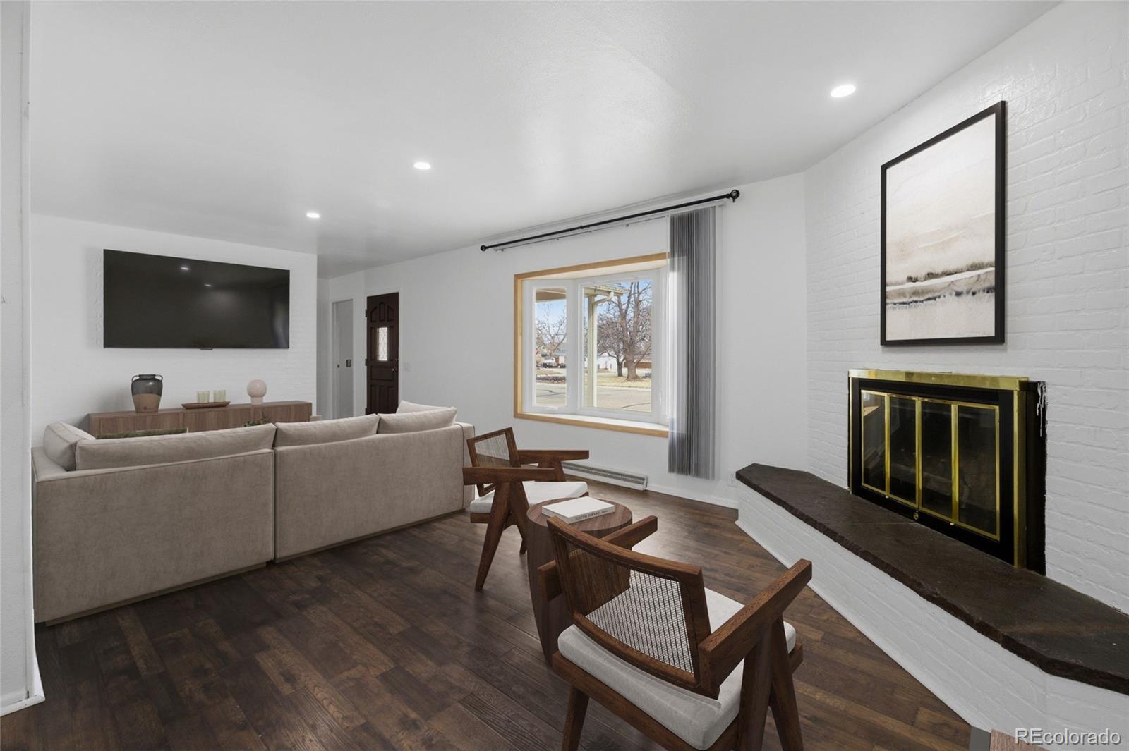 308 Fifth Street Dacono, CO 80514 - Photo 5 of 29 a living room with furniture and a flat screen tv