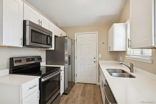 a kitchen with a sink stove and microwave