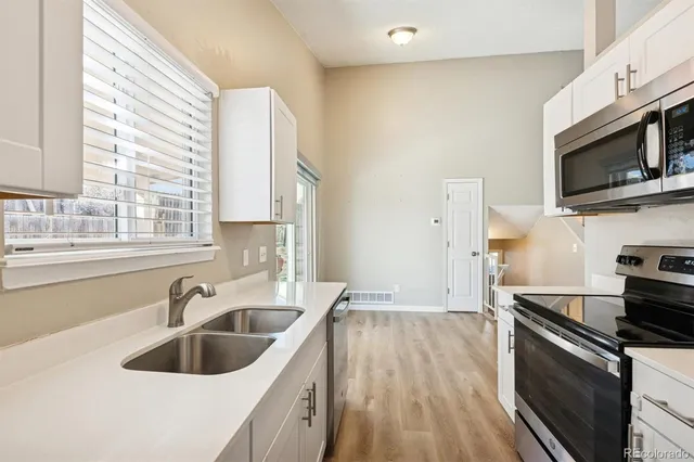 a kitchen with a sink and a stove top oven