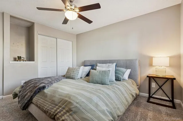 a bedroom with a bed and a lamp on table