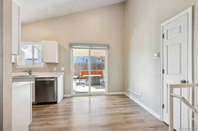 a view of a kitchen with a sink stove cabinets and a window