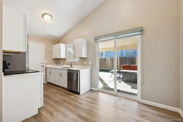 a kitchen with a stove a sink and a refrigerator
