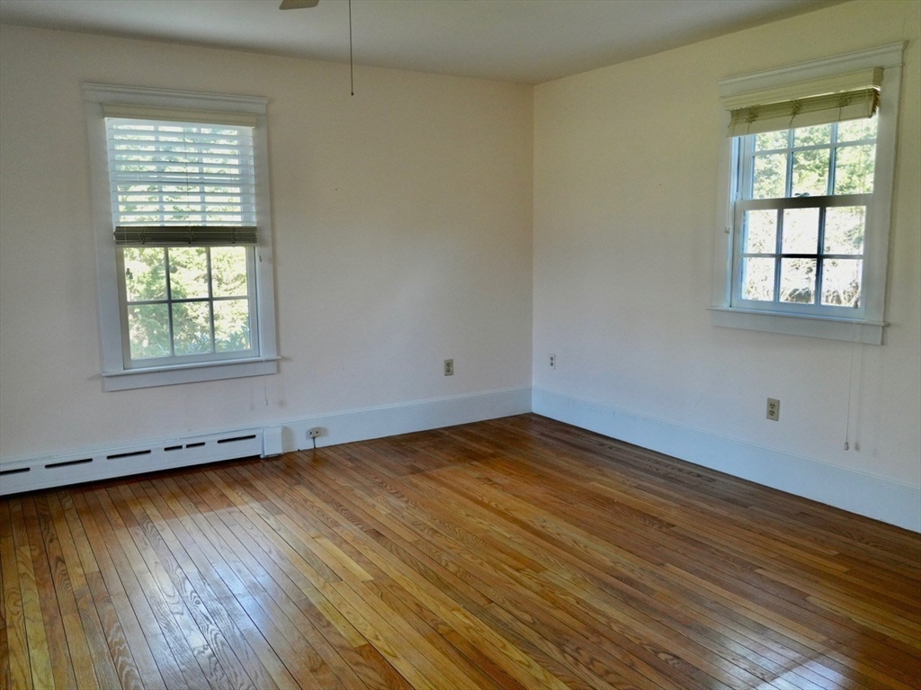 45 Bumblebee Hill Road Falmouth, MA 02540 - Photo 13 of 30 an empty room with wooden floor and windows