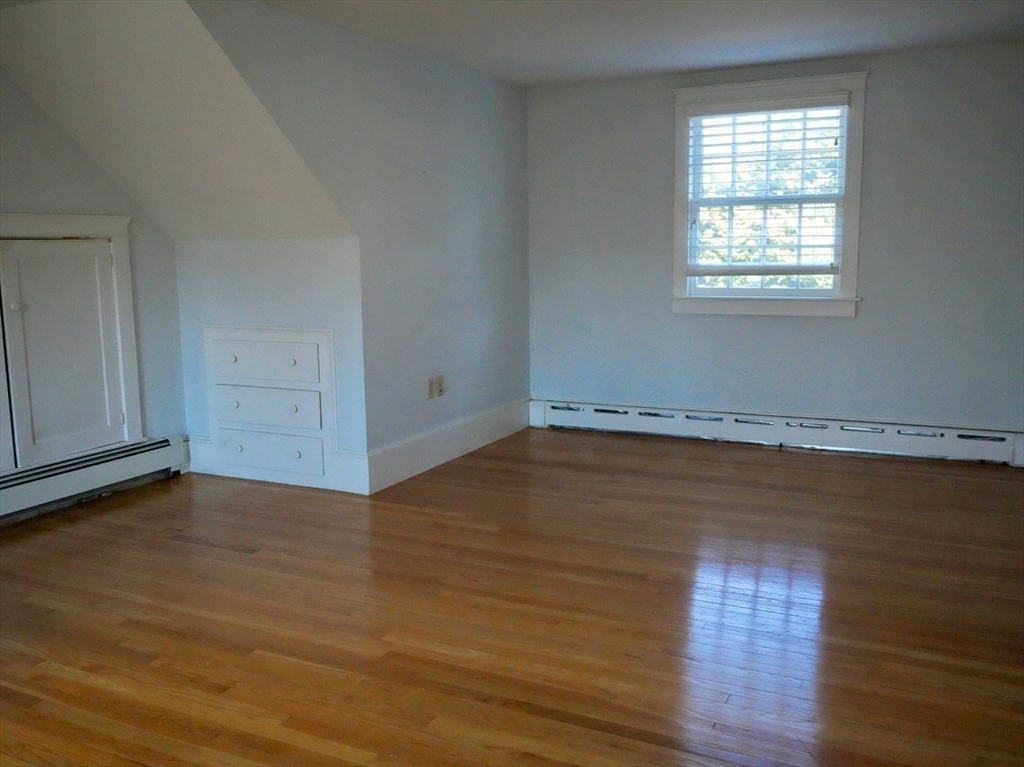 45 Bumblebee Hill Road Falmouth, MA 02540 - Photo 18 of 30 an empty room with wooden floor and windows