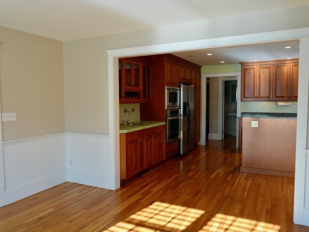 45 Bumblebee Hill Road Falmouth, MA 02540 - Photo 7 of 30 a kitchen with stainless steel appliances granite countertop a refrigerator and a wooden cabinets