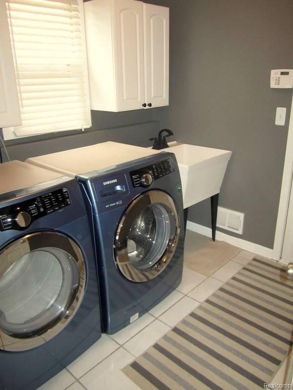 716 Lake Ridge Road Rochester, MI 48307 - Photo 13 of 30 First Floor Laundry with Newer Washer and Dryer, with Access to Garage