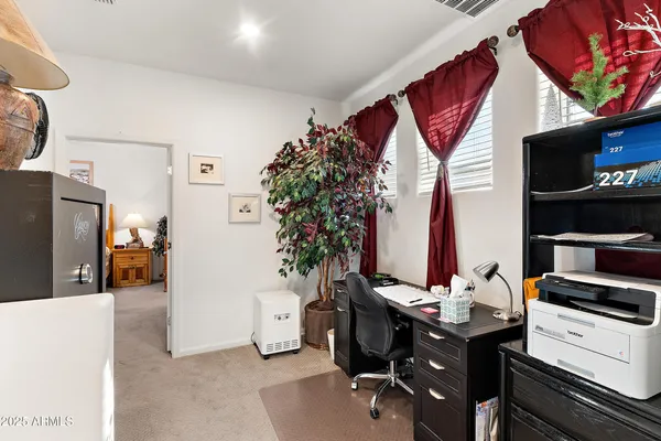 a view of a workspace with furniture and a flat screen tv