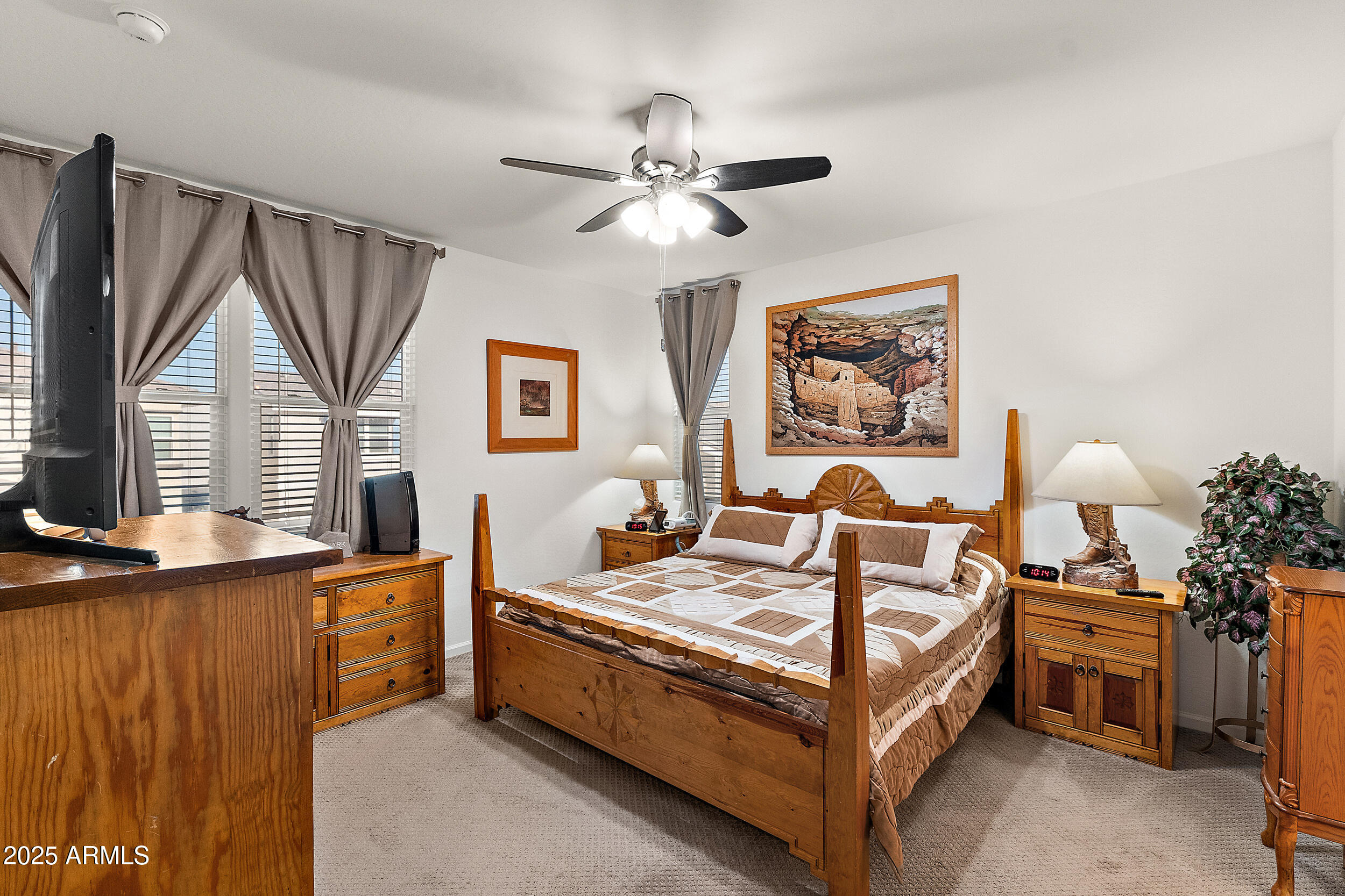 1921 West 22nd Avenue Apache Junction, AZ 85120 - Photo 13 of 38 a bedroom with a bed and a chandelier