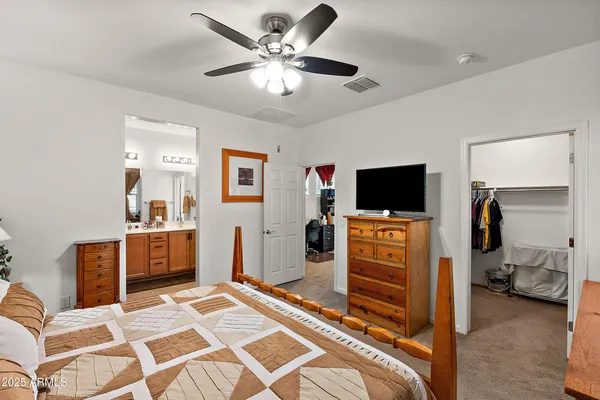a bedroom with furniture and a flat screen tv