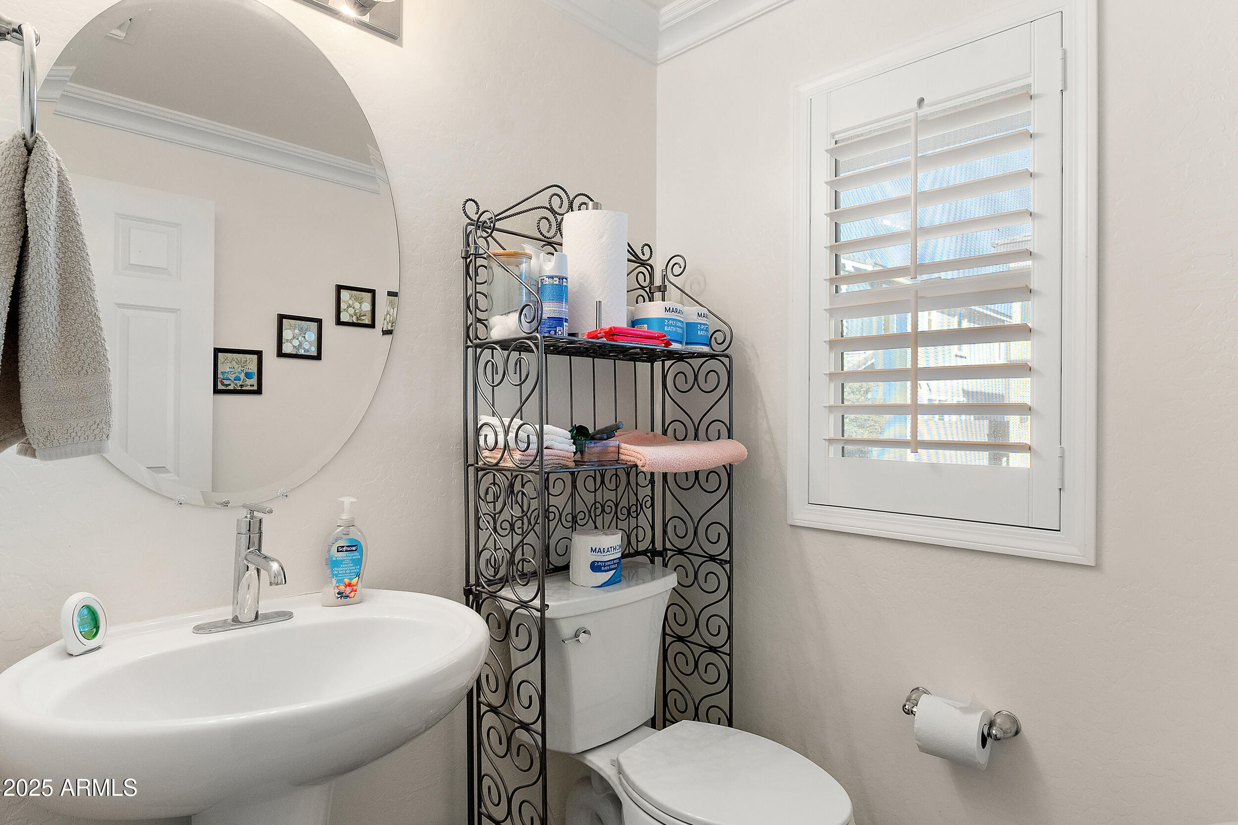 1921 West 22nd Avenue Apache Junction, AZ 85120 - Photo 21 of 38 a bathroom with a sink a toilet and a mirror