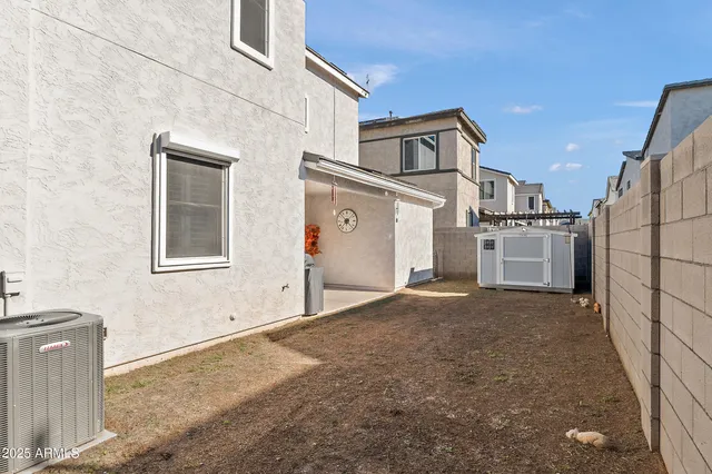 a view of a blue house with a street