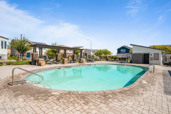 a view of a swimming pool with outdoor seating
