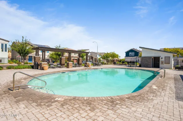 a view of a swimming pool with outdoor seating
