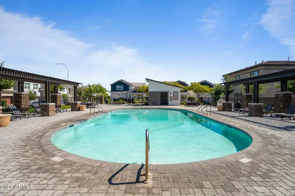 a view of a swimming pool with outdoor seating