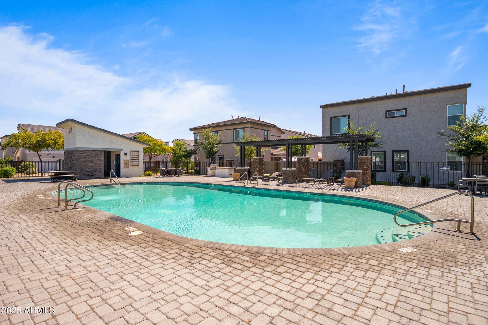 1921 West 22nd Avenue Apache Junction, AZ 85120 - Photo 31 of 38 a swimming pool with outdoor seating and yard