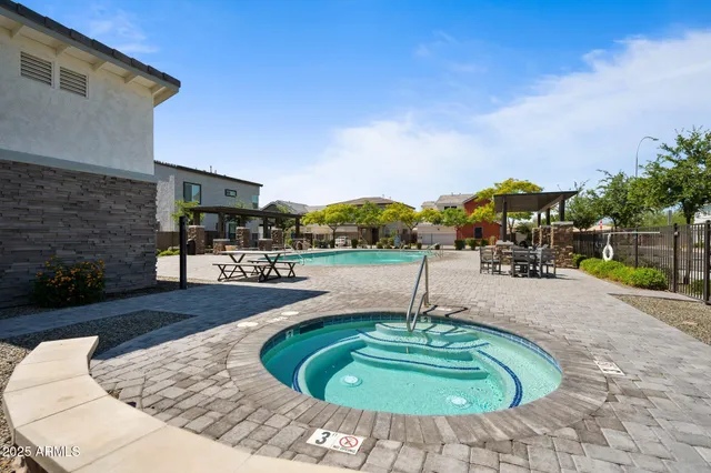 a swimming pool with outdoor seating and outdoor seating