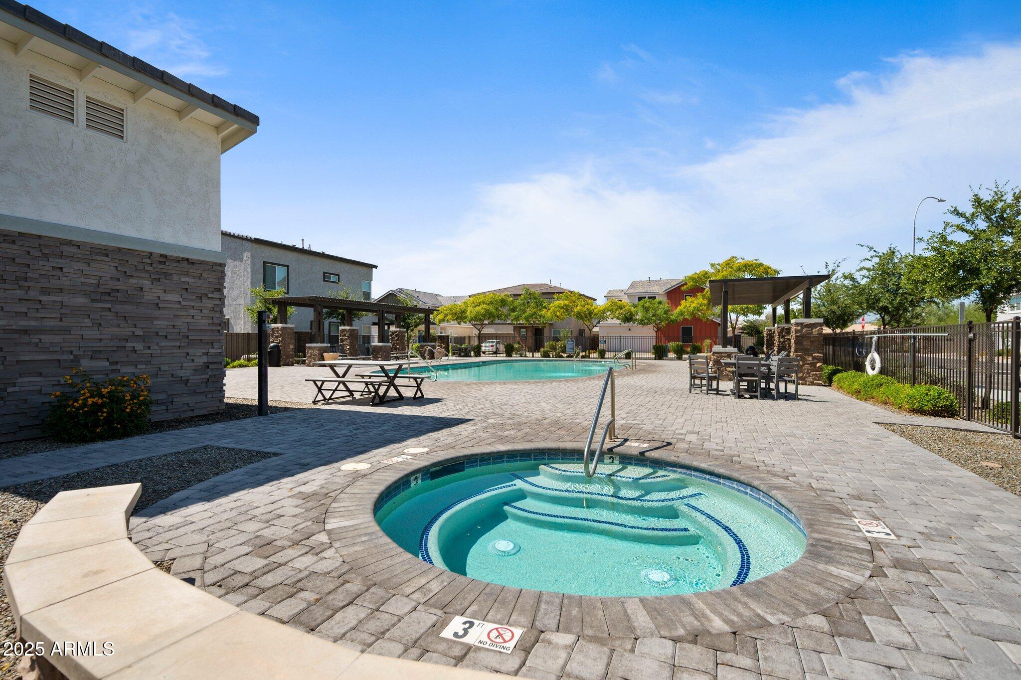 1921 West 22nd Avenue Apache Junction, AZ 85120 - Photo 32 of 38 a swimming pool with outdoor seating and outdoor seating
