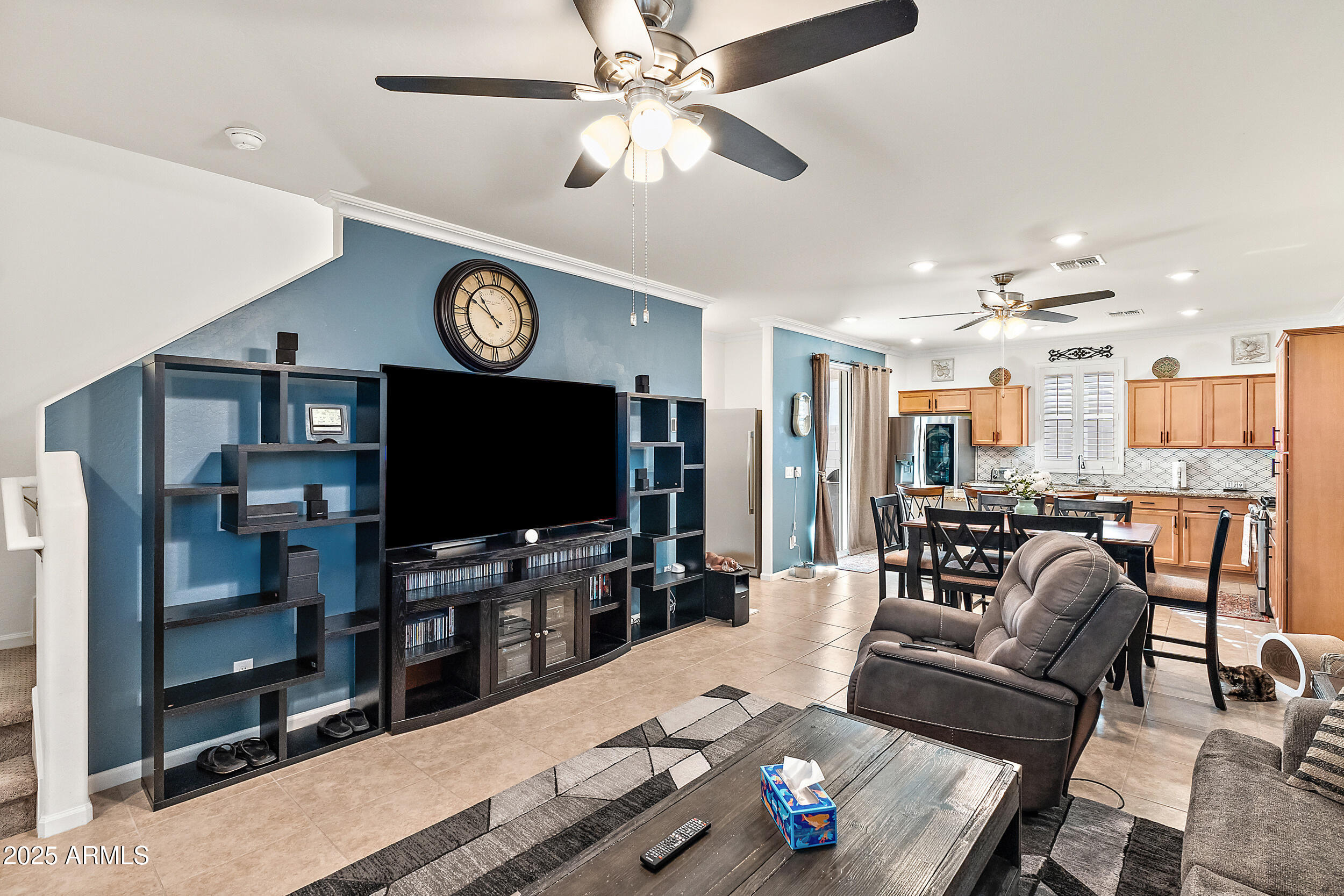 1921 West 22nd Avenue Apache Junction, AZ 85120 - Photo 4 of 38 a living room with furniture a flat screen tv and kitchen view