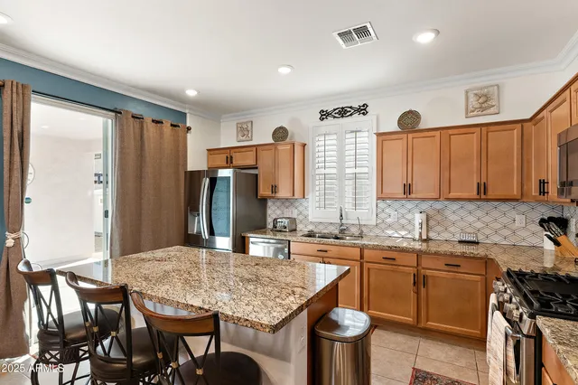 a kitchen with a stove a sink and a refrigerator