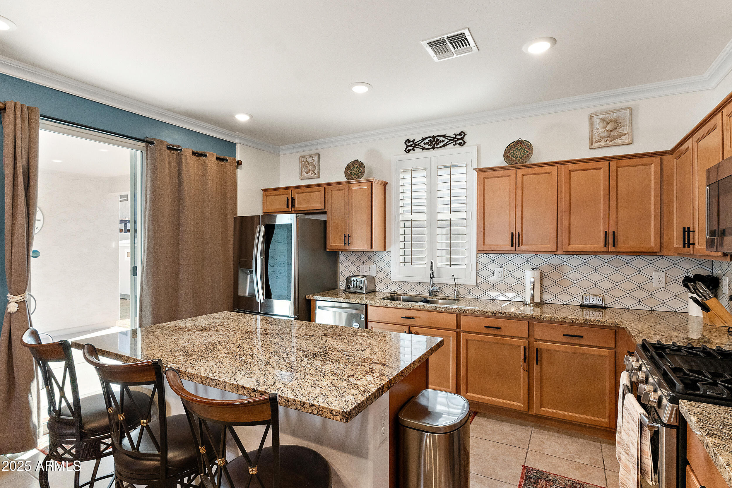 1921 West 22nd Avenue Apache Junction, AZ 85120 - Photo 8 of 38 a kitchen with a stove a sink and a refrigerator