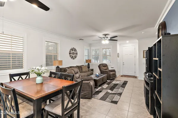 a living room with furniture a large window and a chandelier