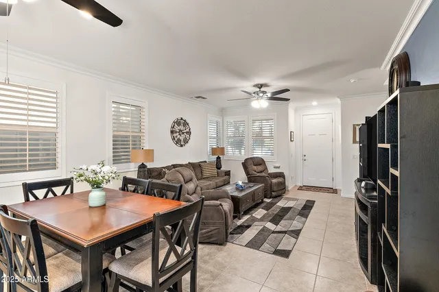 a living room with furniture a large window and a chandelier