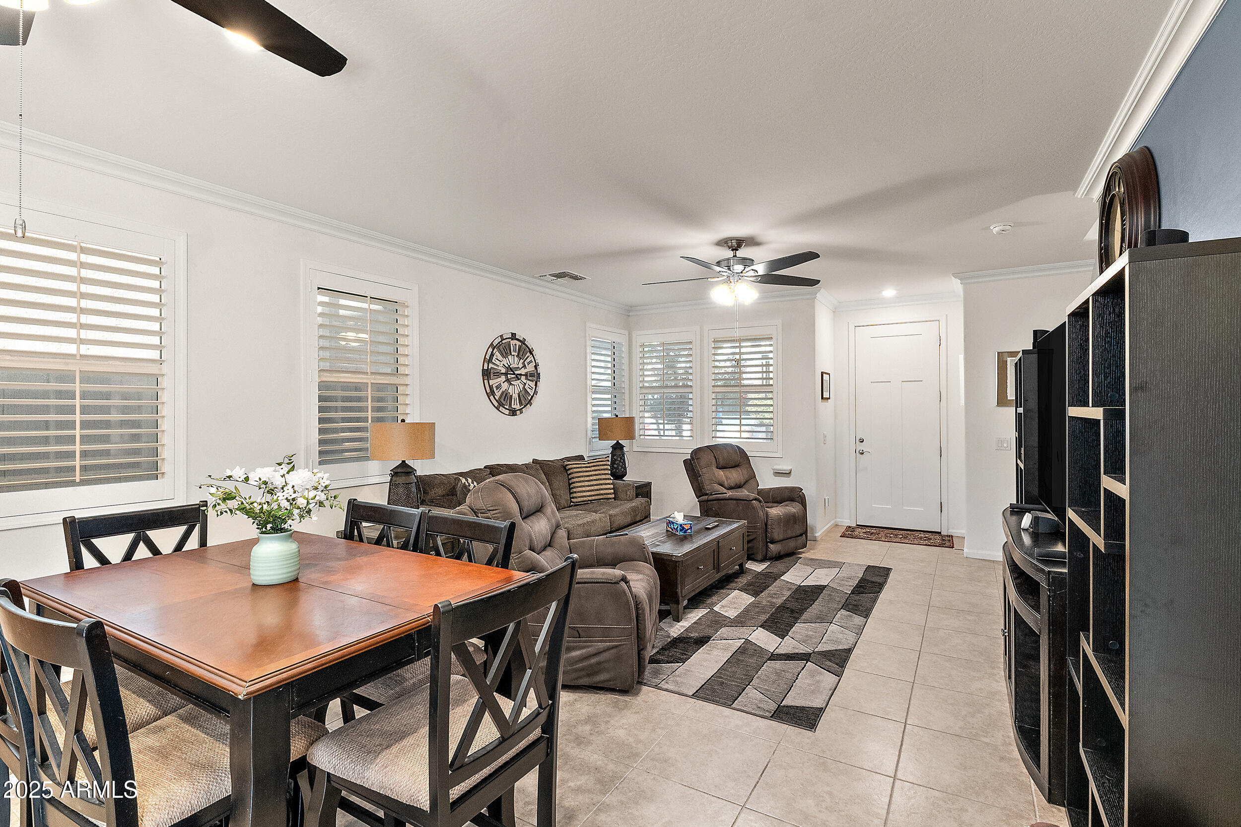 1921 West 22nd Avenue Apache Junction, AZ 85120 - Photo 10 of 38 a living room with furniture a large window and a chandelier
