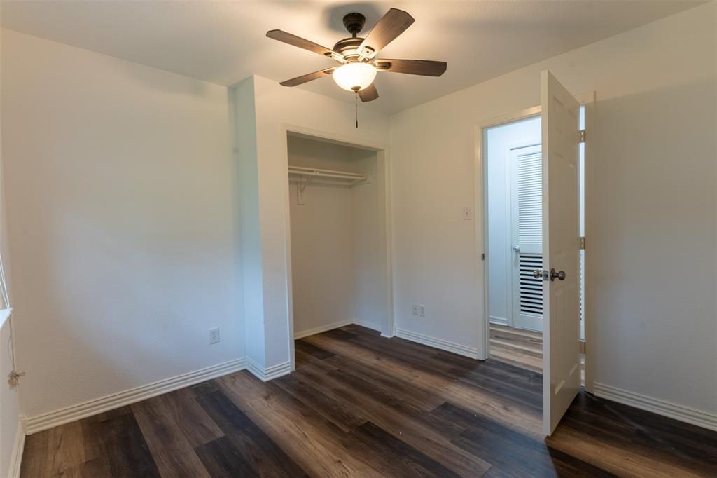 1285 Clark Road Gainesville, TX 76240 - Photo 9 of 20 This room features dark-toned wood-style flooring, white baseboards, and a ceiling fan with integrated lighting