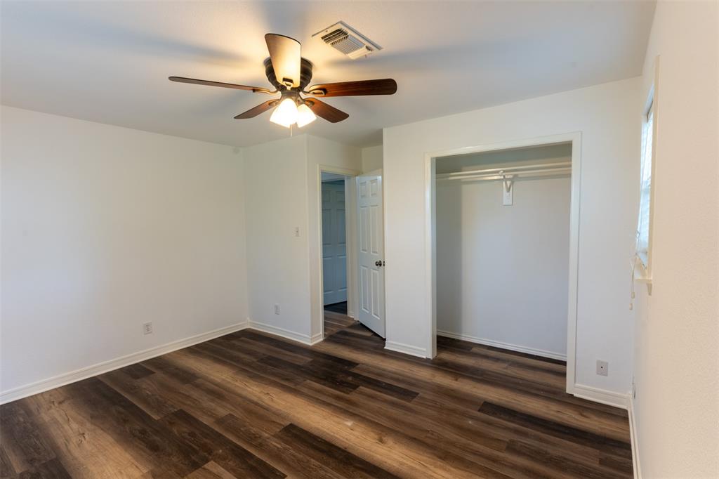 1285 Clark Road Gainesville, TX 76240 - Photo 10 of 20 This room features rich wood-style flooring, a ceiling fan with integrated lighting, and a closet with hanging rods