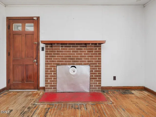 a view of an empty room with cabinet and a window