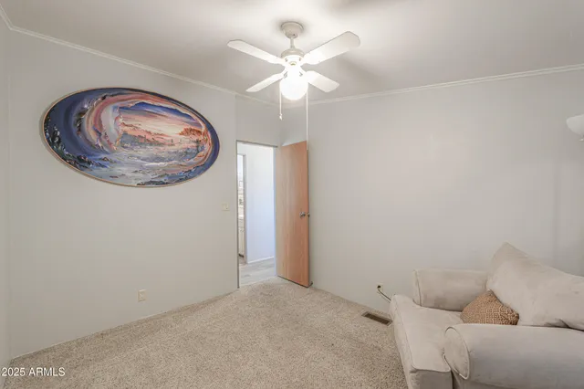 a living room with furniture and a ceiling fan