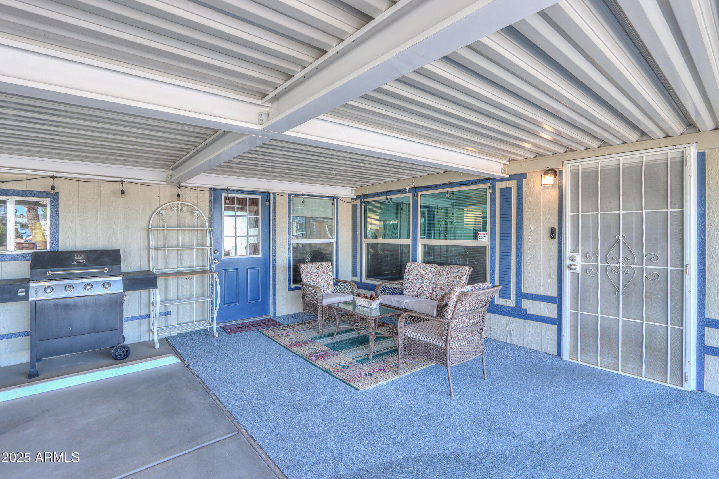 2208 West Baseline Avenue, Unit 40 Apache Junction, AZ 85120 - Photo 18 of 30 a living room with furniture and large windows