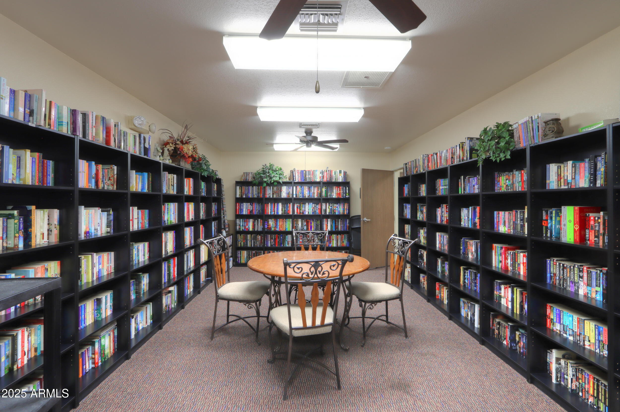 2208 West Baseline Avenue, Unit 40 Apache Junction, AZ 85120 - Photo 26 of 30 a view of a a dining room with furniture and a book shelf