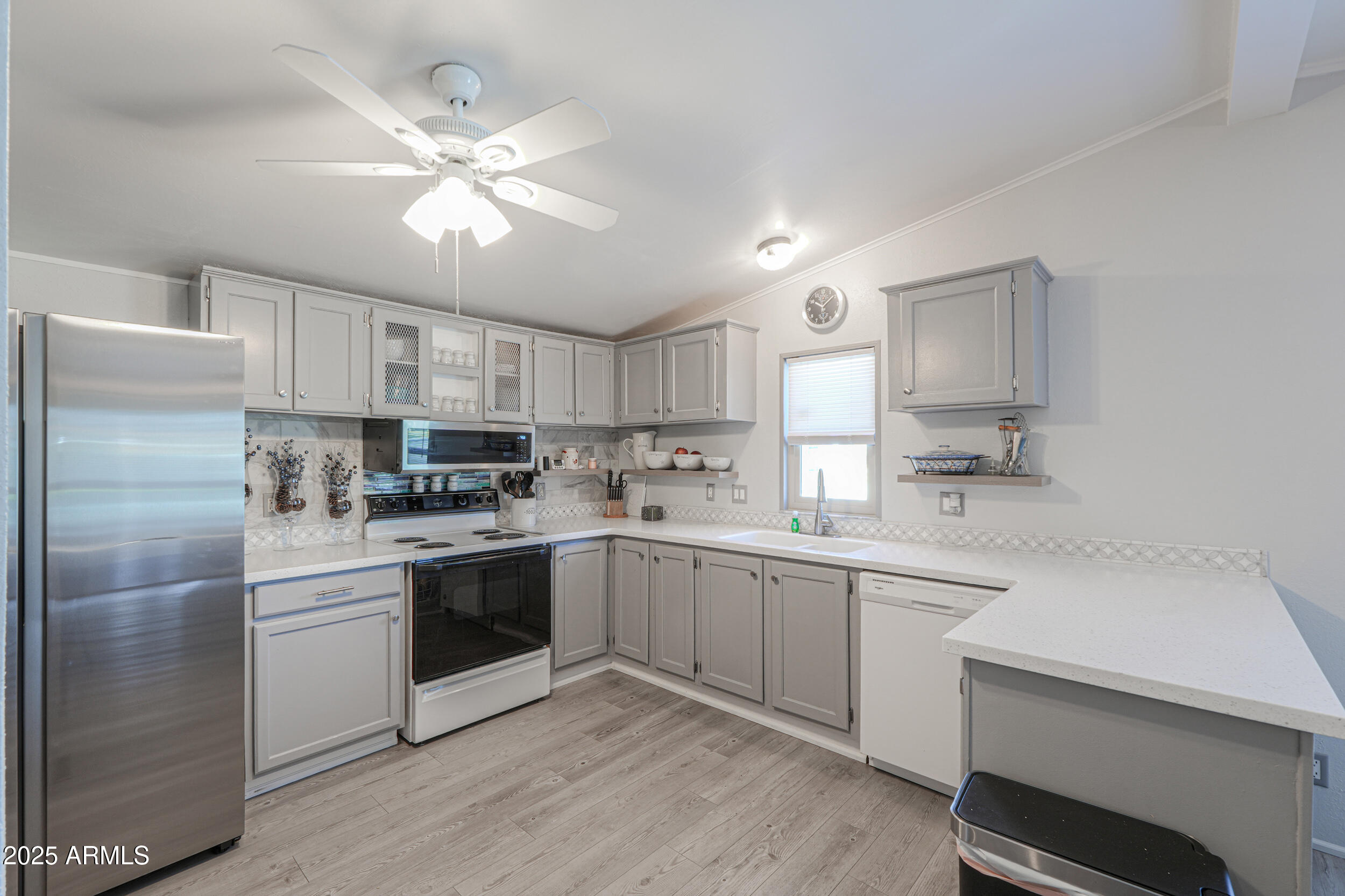 2208 West Baseline Avenue, Unit 40 Apache Junction, AZ 85120 - Photo 4 of 30 a kitchen with a white cabinets and white appliances