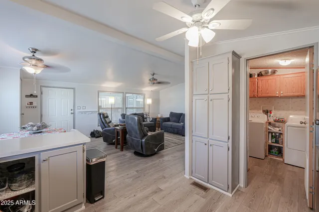 a utility room with fridge dryer and washer