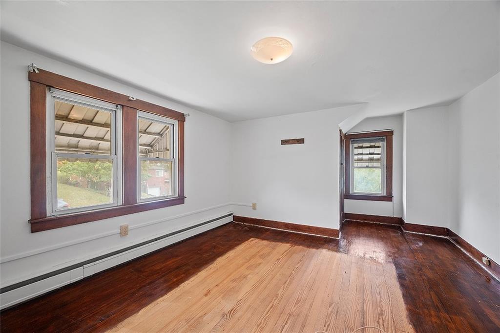 3708 Grant Street Pittsburgh, PA 15234 - Photo 12 of 36 an empty room with wooden floor and windows