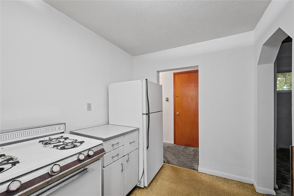 3708 Grant Street Pittsburgh, PA 15234 - Photo 23 of 36 a kitchen with a stove and a refrigerator