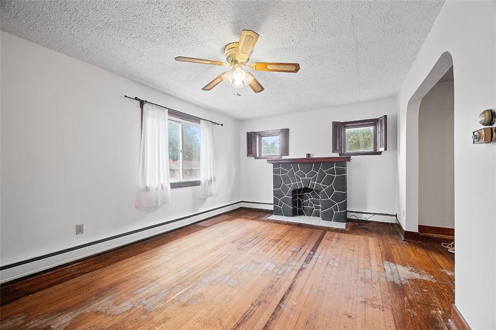 3708 Grant Street Pittsburgh, PA 15234 - Photo 4 of 36 a view of an empty room with window and wooden floor