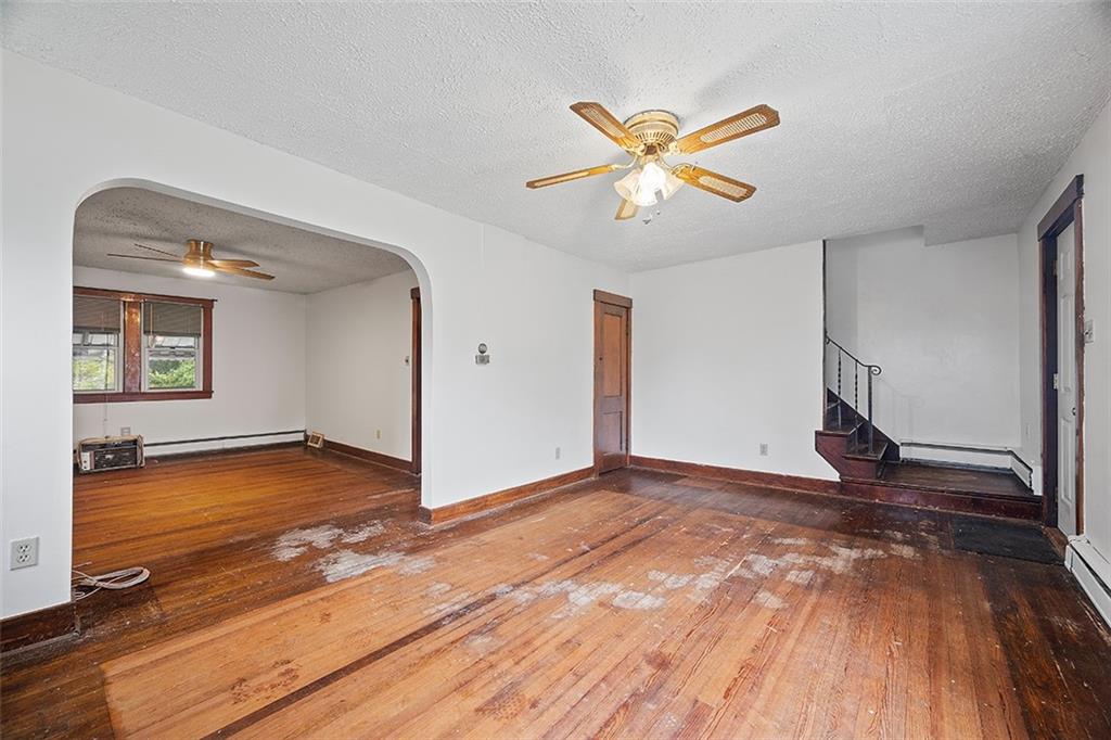 3708 Grant Street Pittsburgh, PA 15234 - Photo 5 of 36 a view of a livingroom with wooden floor and ceiling fan